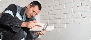 specialist grinds tile before fixing it wall builder decorates walls apartment finishing building with modern materials