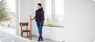 woman with paint roller new apartment