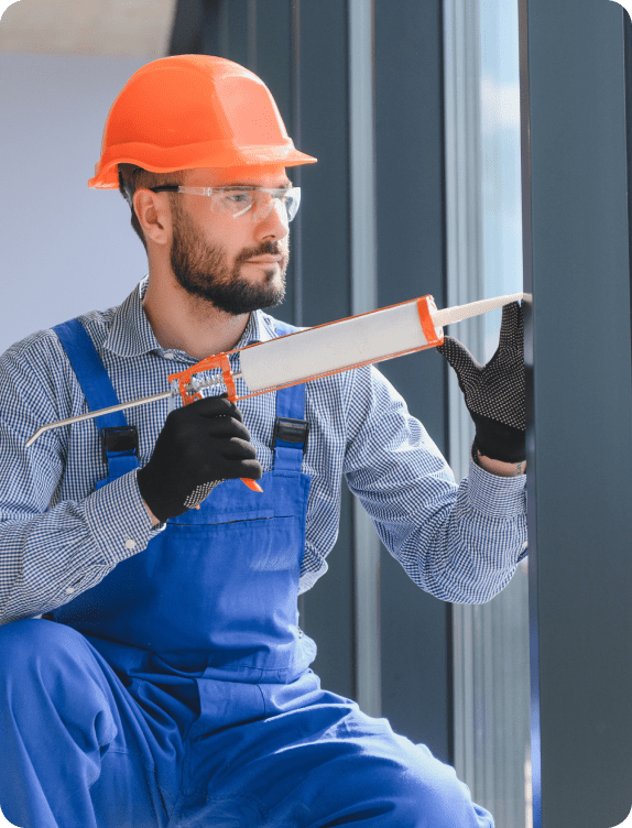 workers with tube sealant suction lifters installing plastic windows indoors